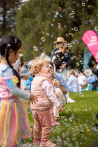 Children watching bubbles at a picnic