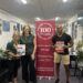 Image of 3 people with one holding the latest course guide. The three people in the image are (L to R) Nerys Thompson, Inga Rosenberg, Jay Reddy
