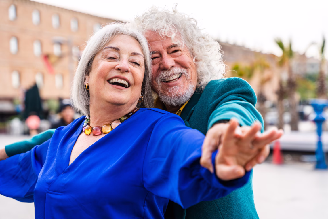 Senior couple of old people dating outdoors - Married elderly man and woman in love spending time together - Grandparents having fun strolling in the city