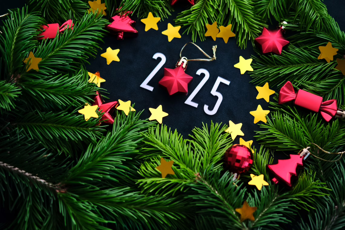 New Year 2025 background. Number of the coming year in a beautiful Christmas decoration with red toys and green fir branches. High quality photo