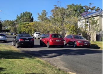 A view of a residential street in Berowra with cars parked on the side, representing the traffic concerns regarding the proposed narrowing of Anembo Road.
