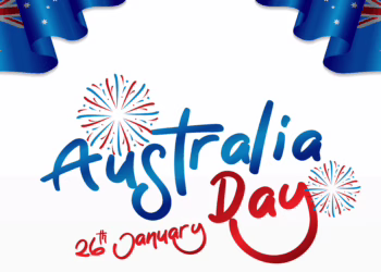 A festive graphic featuring Australian flags waving in the corners, red and blue fireworks, and stylized text reading "Australia Day 26th January".